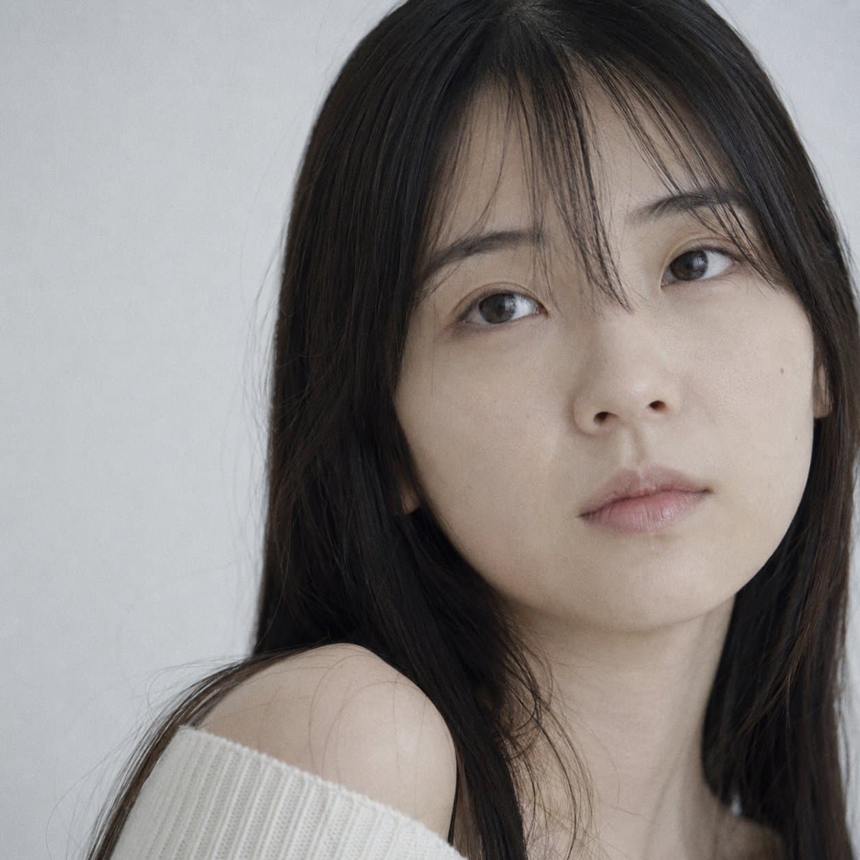 Portrait shot on 85mm f/1.8, tight close-up face portrait of