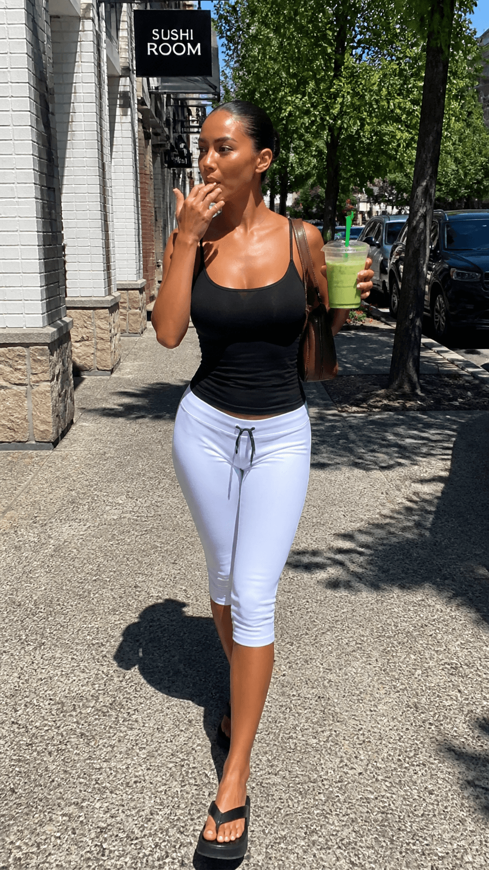 An iPhone-style candid full-body street-style shot of a youn