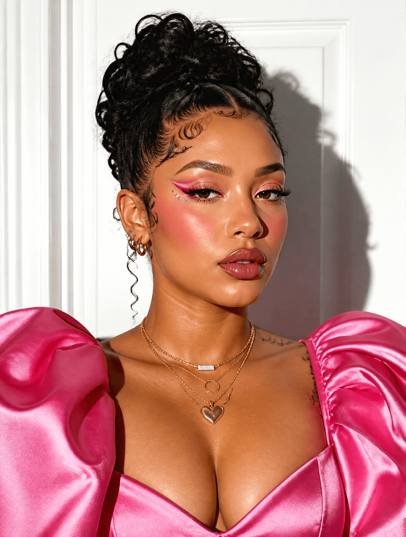 A portrait of a woman with an intricate updo and styled baby
