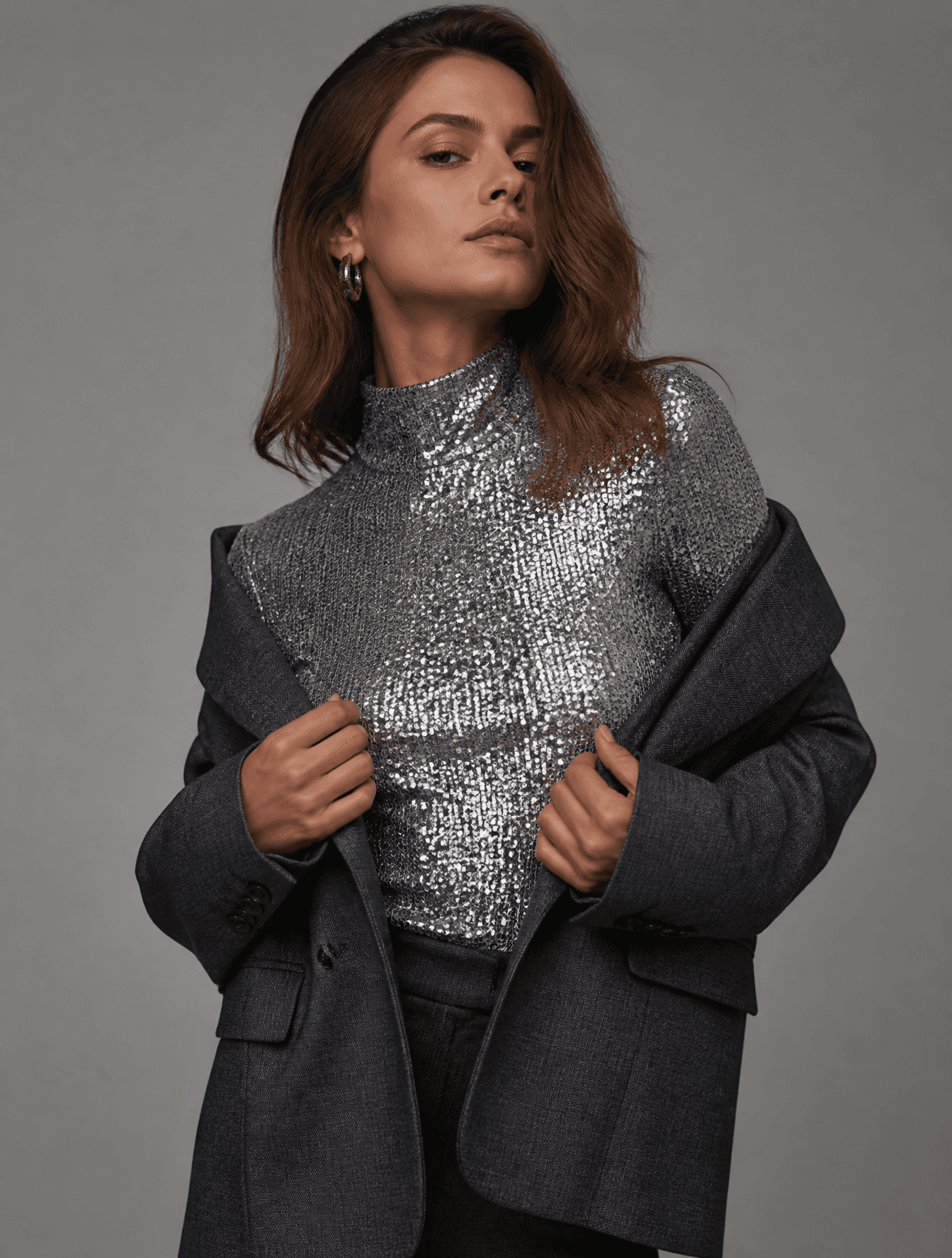 A high-fashion editorial medium shot of an elegant woman sli