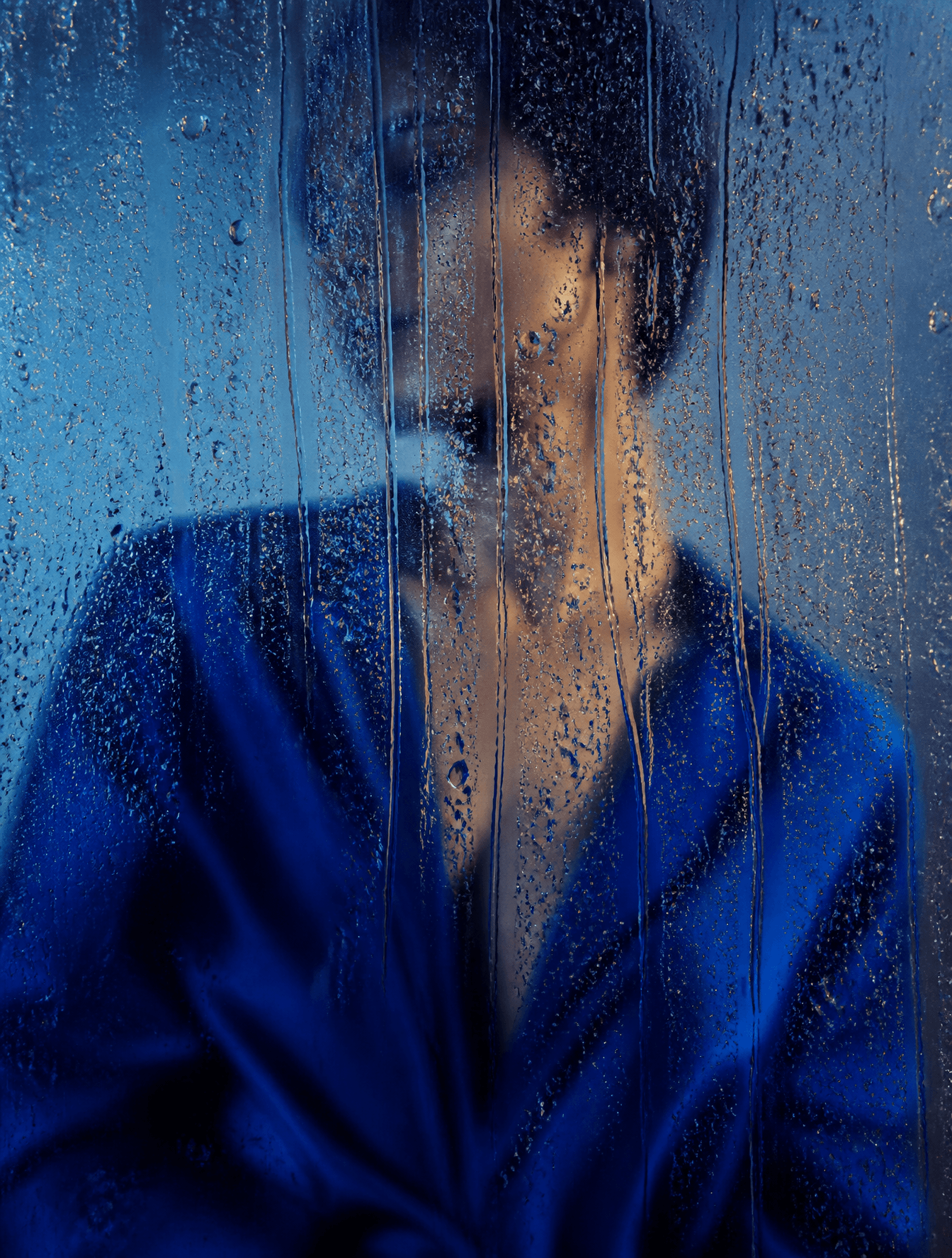 A cinematic editorial fashion photograph of a figure in a sa