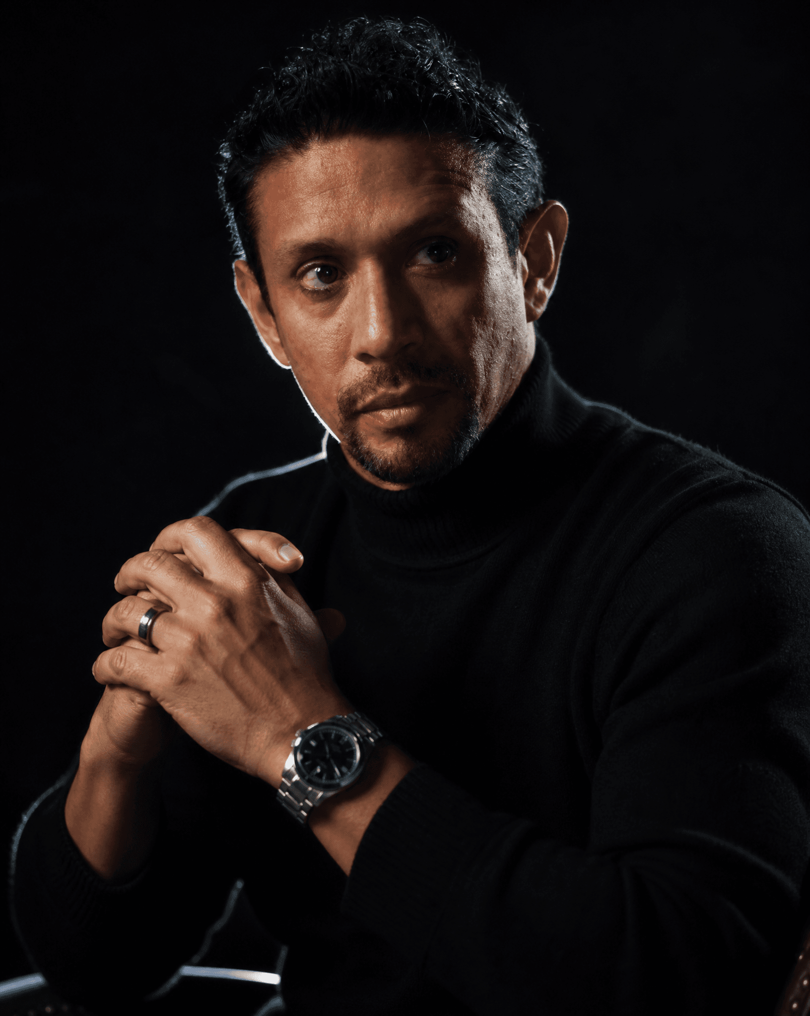A hyper-realistic cinematic portrait of a man with short, te