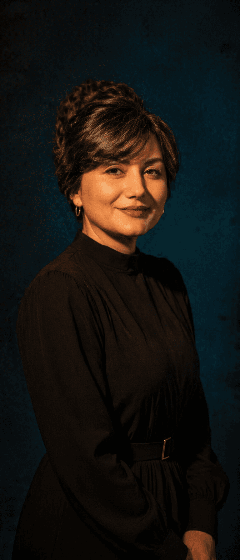 A studio portrait, medium shot of a
woman. High-contrast li
