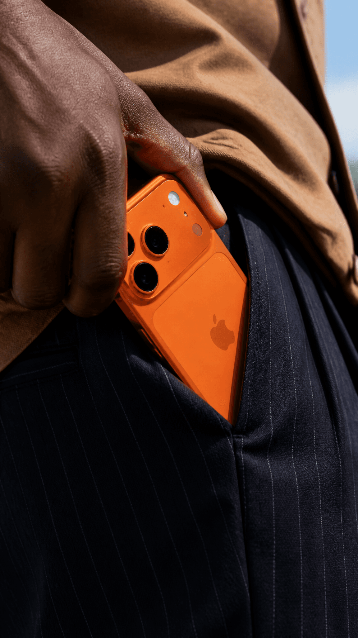 A close-up shot shows a person's dark-skinned hand, likely b