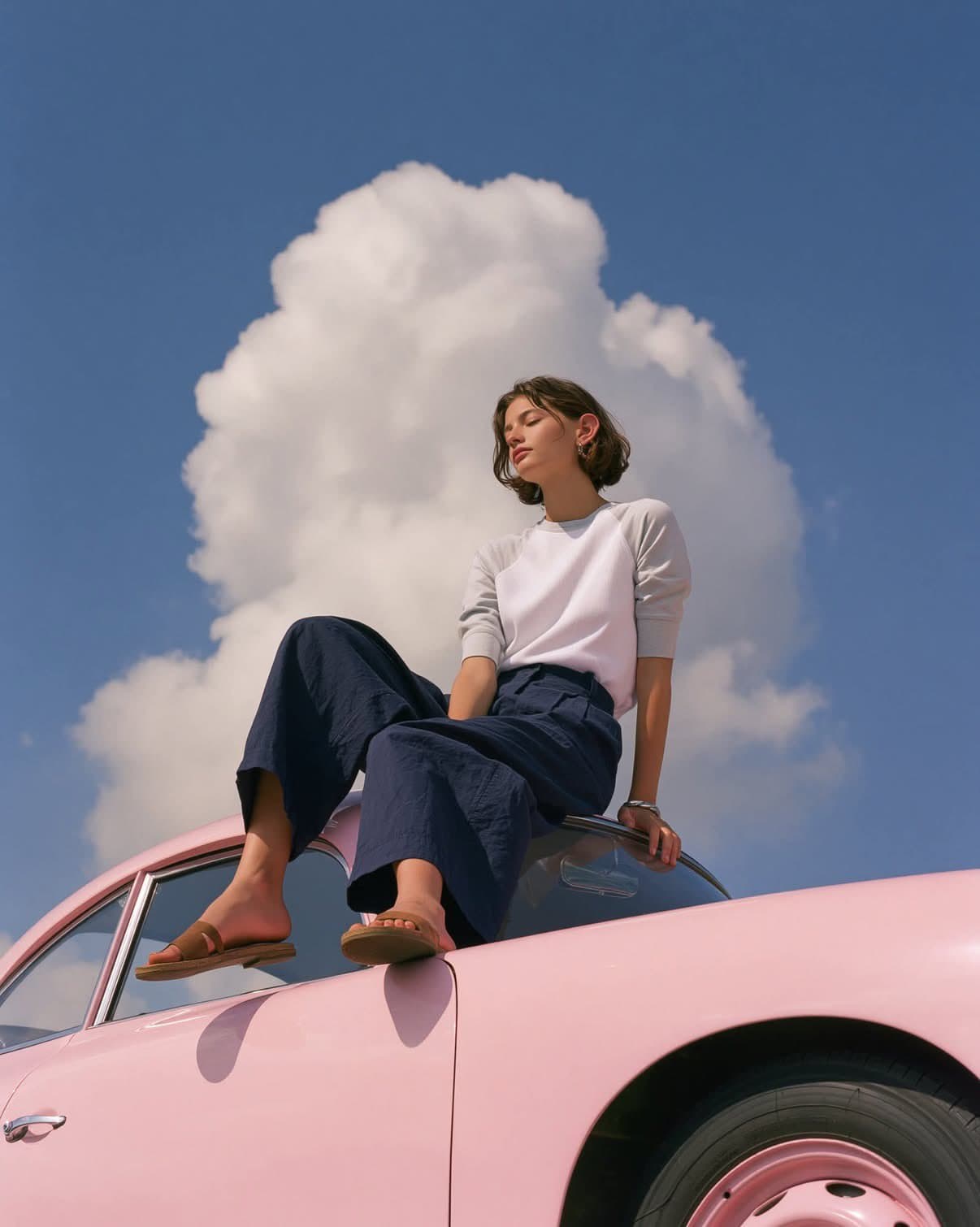 A dreamy editorial fashion photograph of a minimalist young 