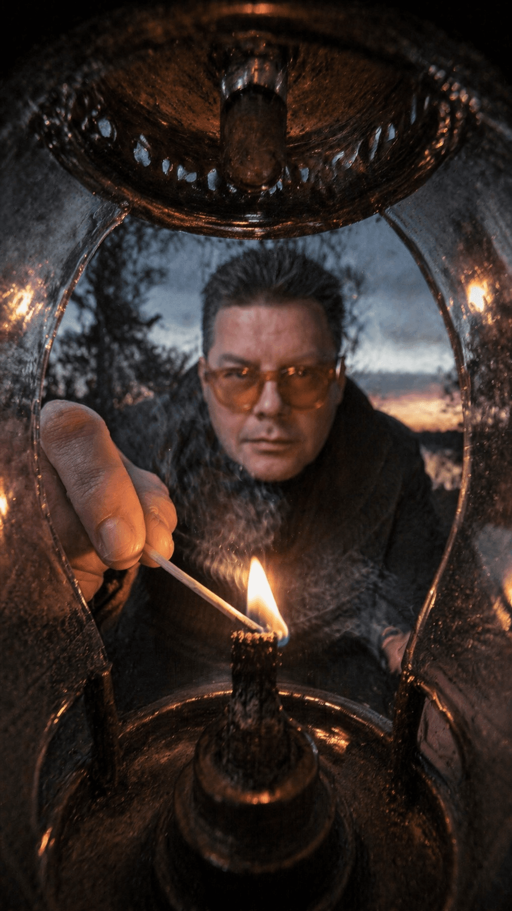 This [image1]in a camper lighting a lantern in the woods at 