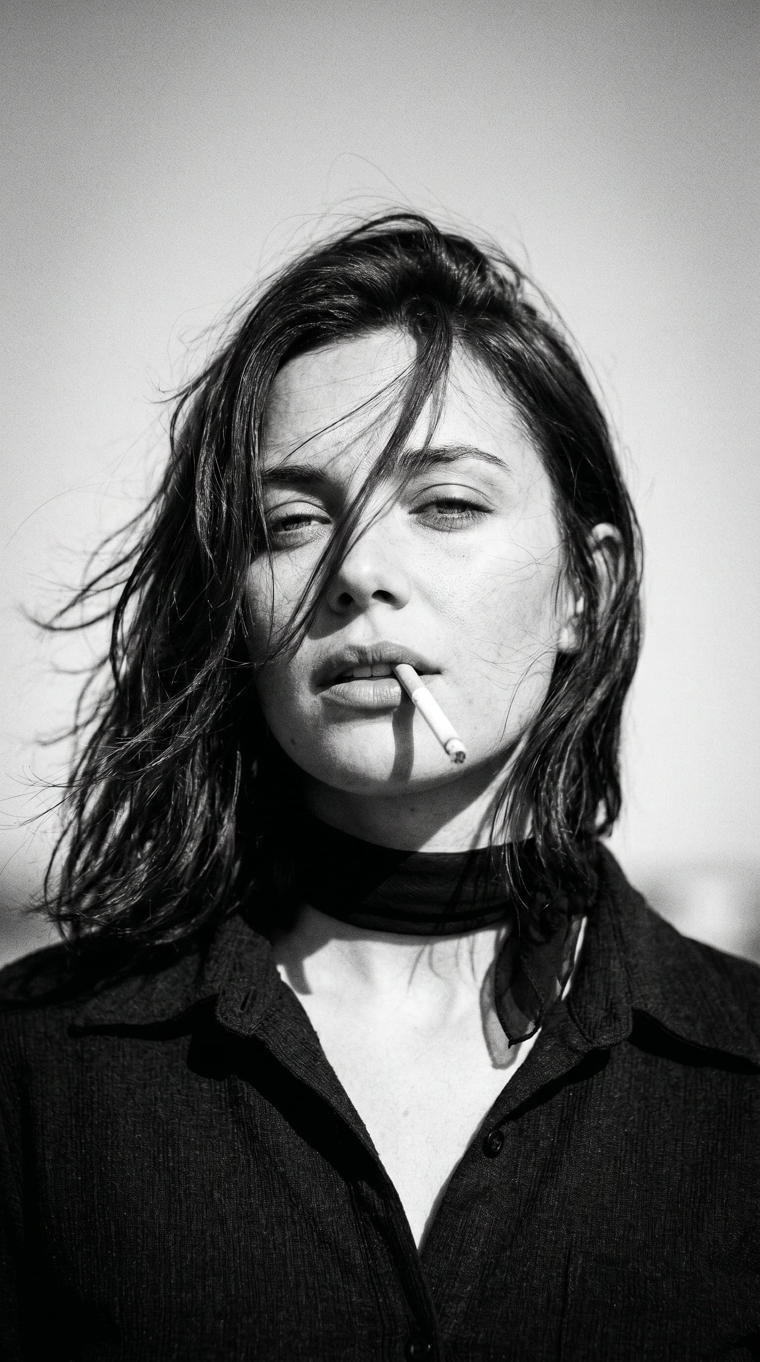 Create a 1970s black-and-white close-up portrait in a windsw