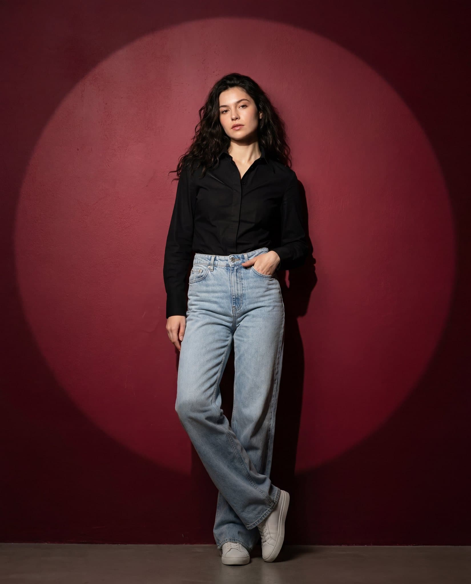 Full-body fashion portrait of a confident woman standing aga