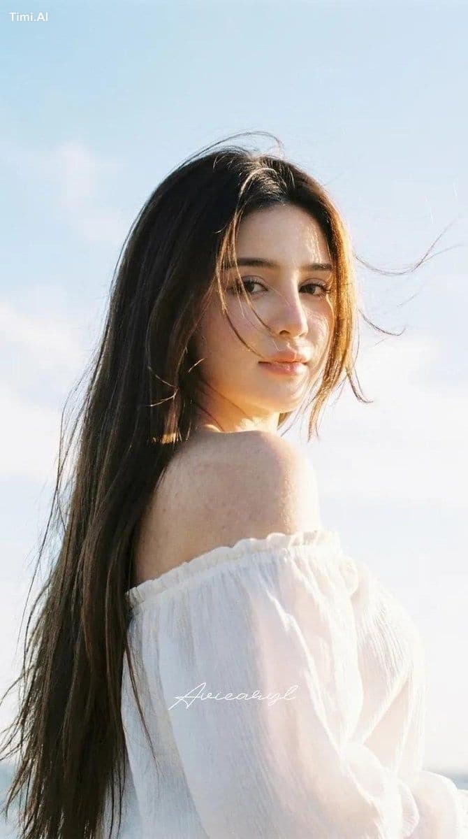 HAIRSTYLE: Ultra‑long, sleek dark brown hair with warm sun‑k
