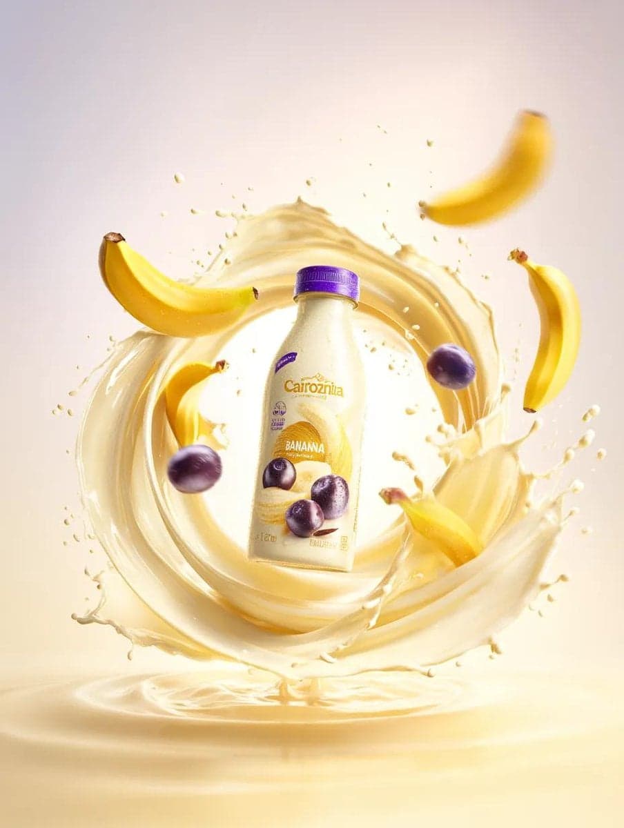 Premium banana milk drink bottle surrounded by swirling milk