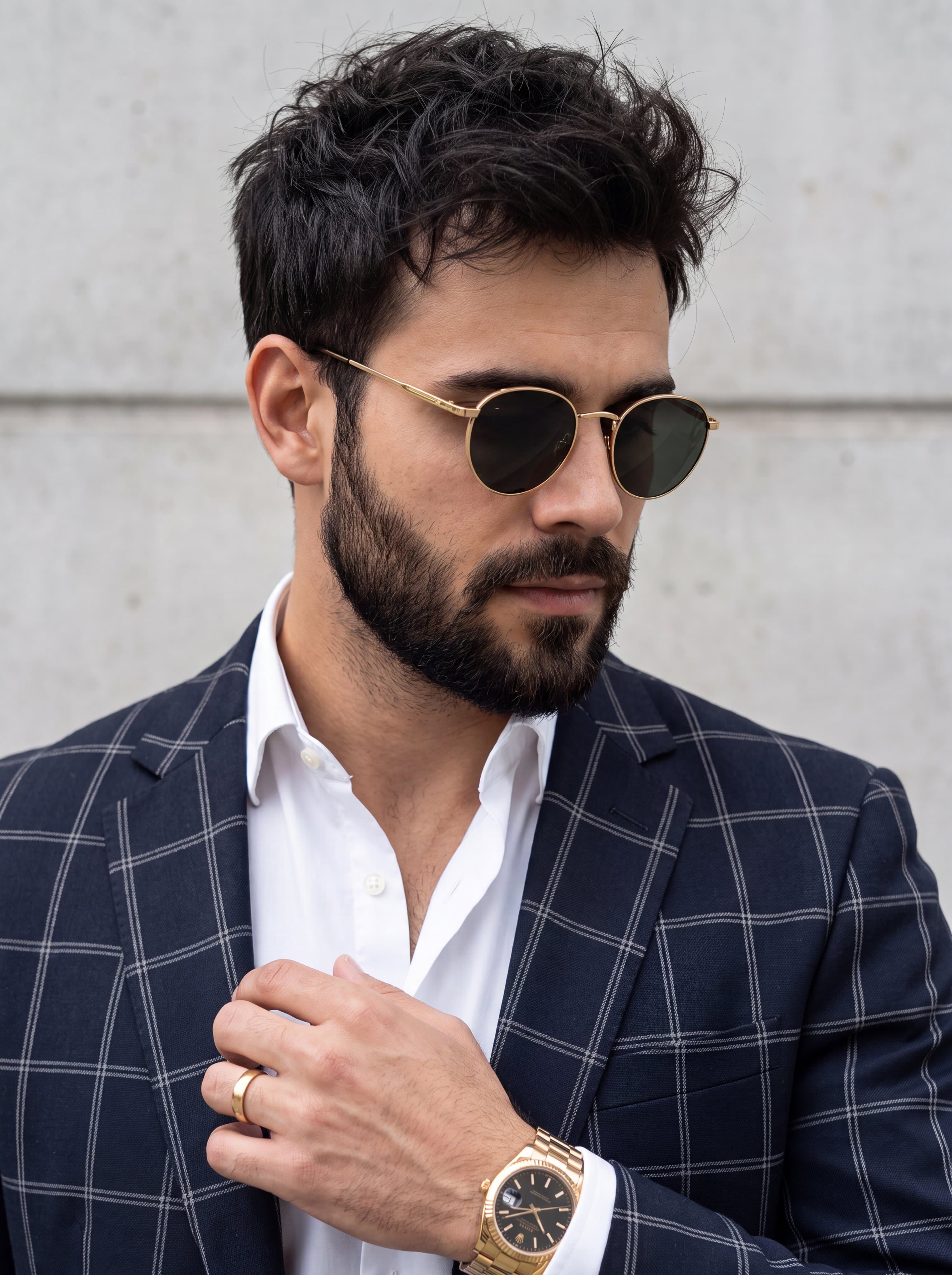 A close-up portrait of a stylish man with a well-groomed bea