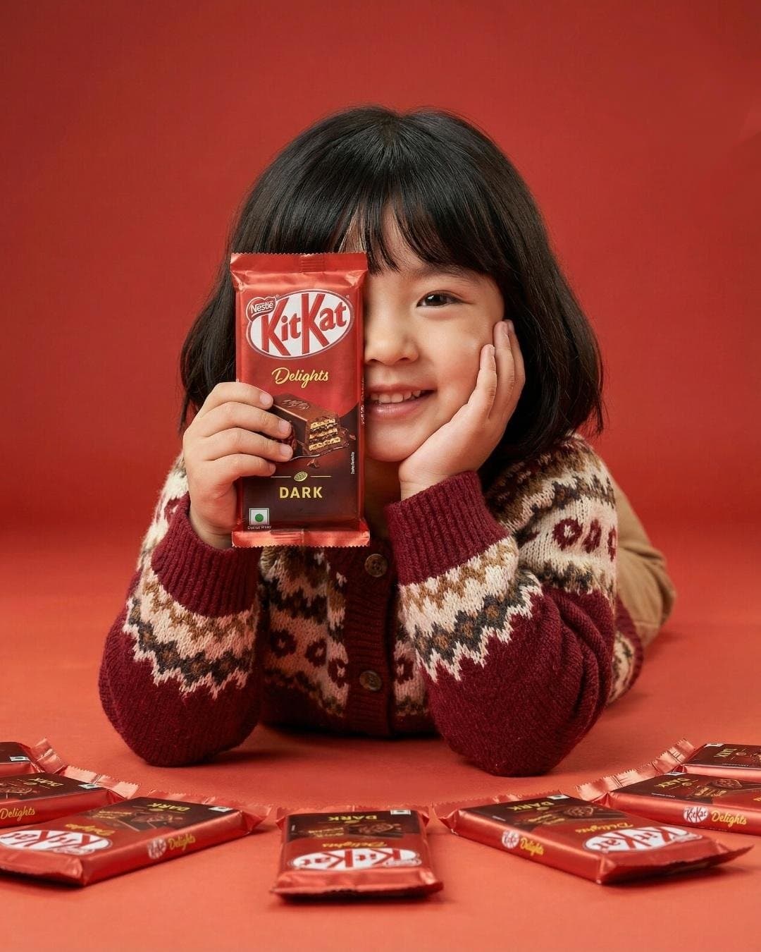 A cute young girl with short black hair and bangs smiling wh
