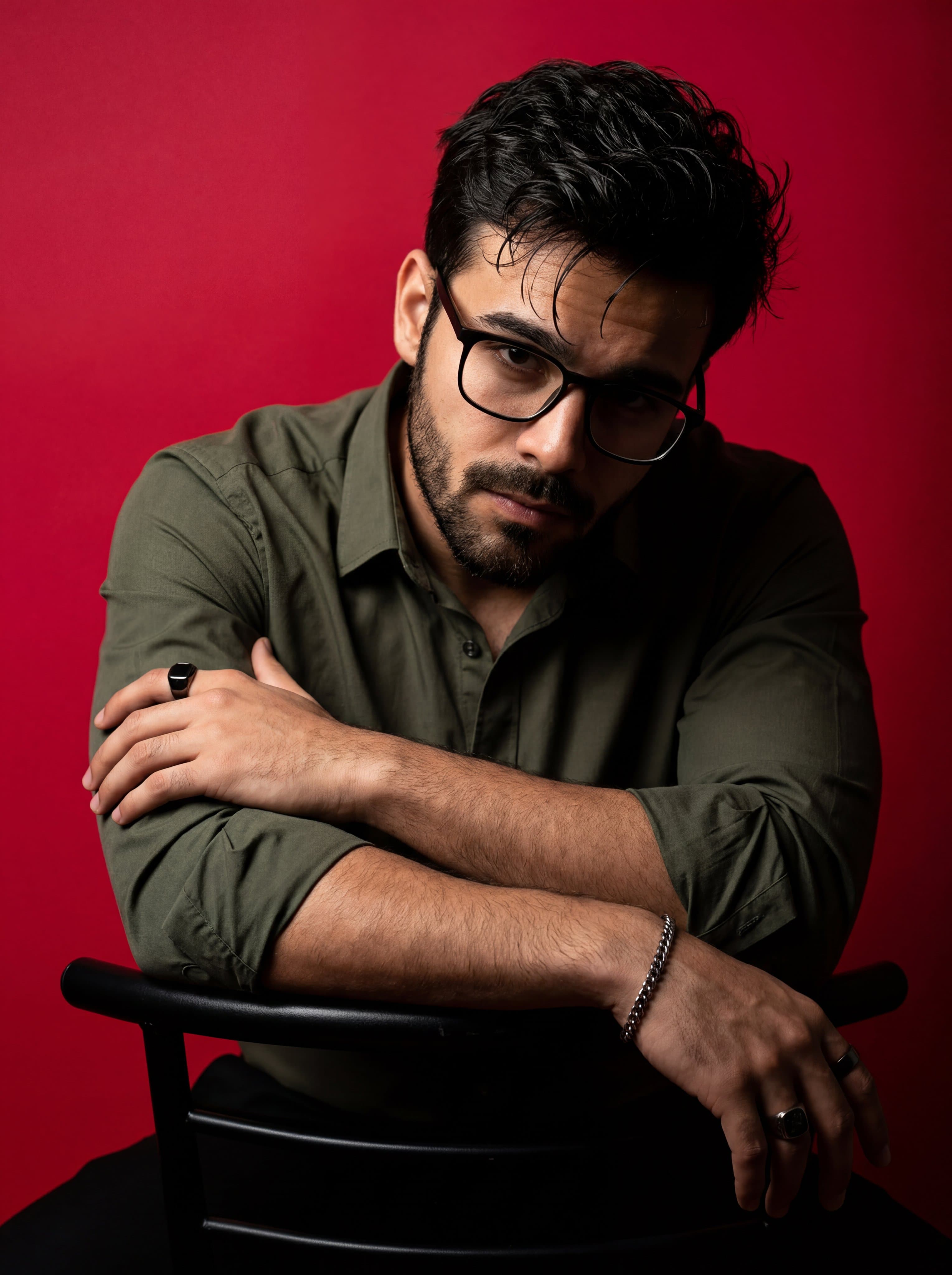 A dramatic, high-contrast studio portrait of a man with dark