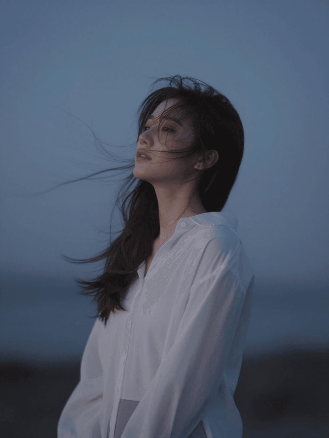 Character reacting deeply to surroundings—wind, music, silen