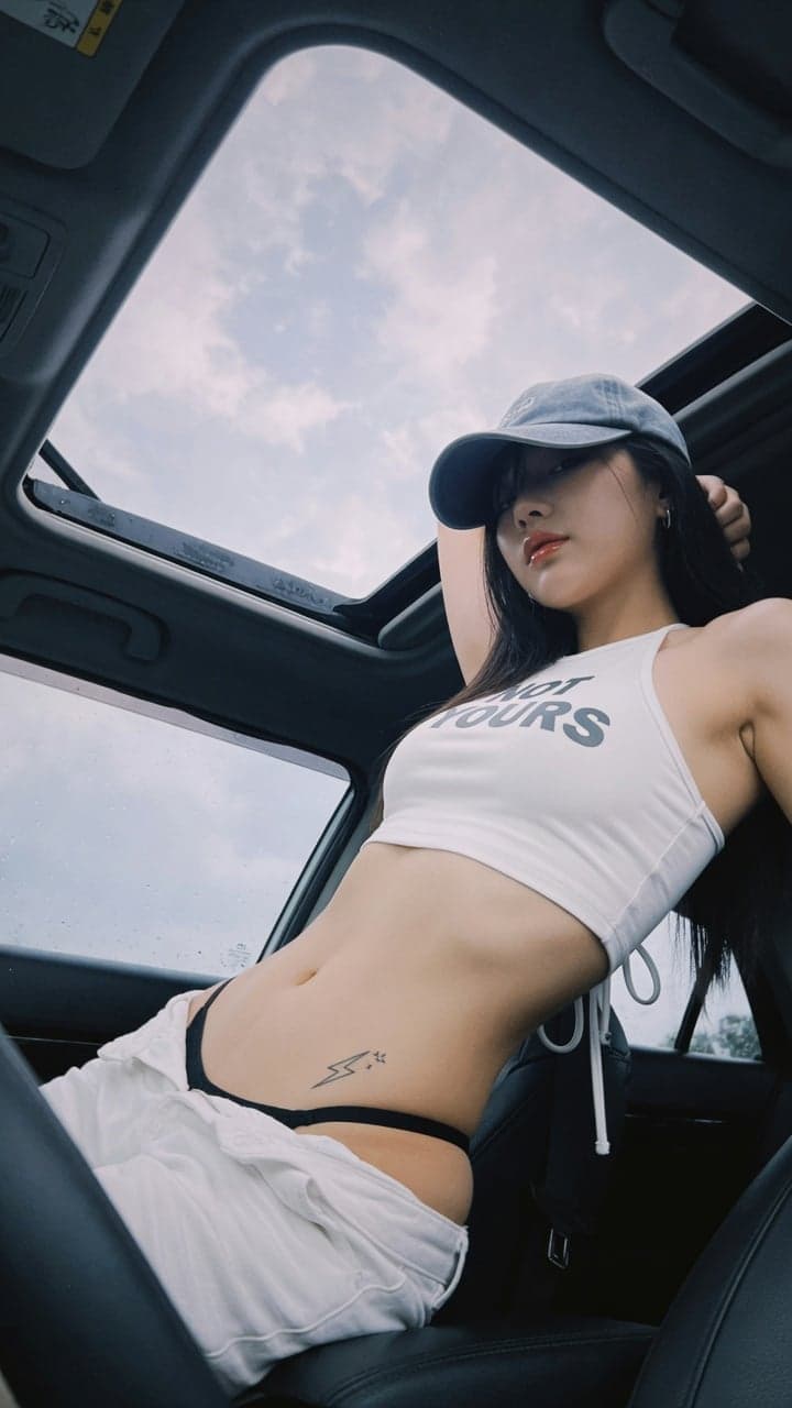 Vertical low-angle candid photo inside car, cool tone film t
