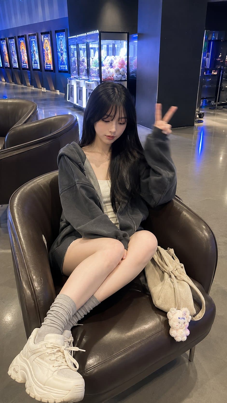 A young East Asian woman in her early 20s sits diagonally in