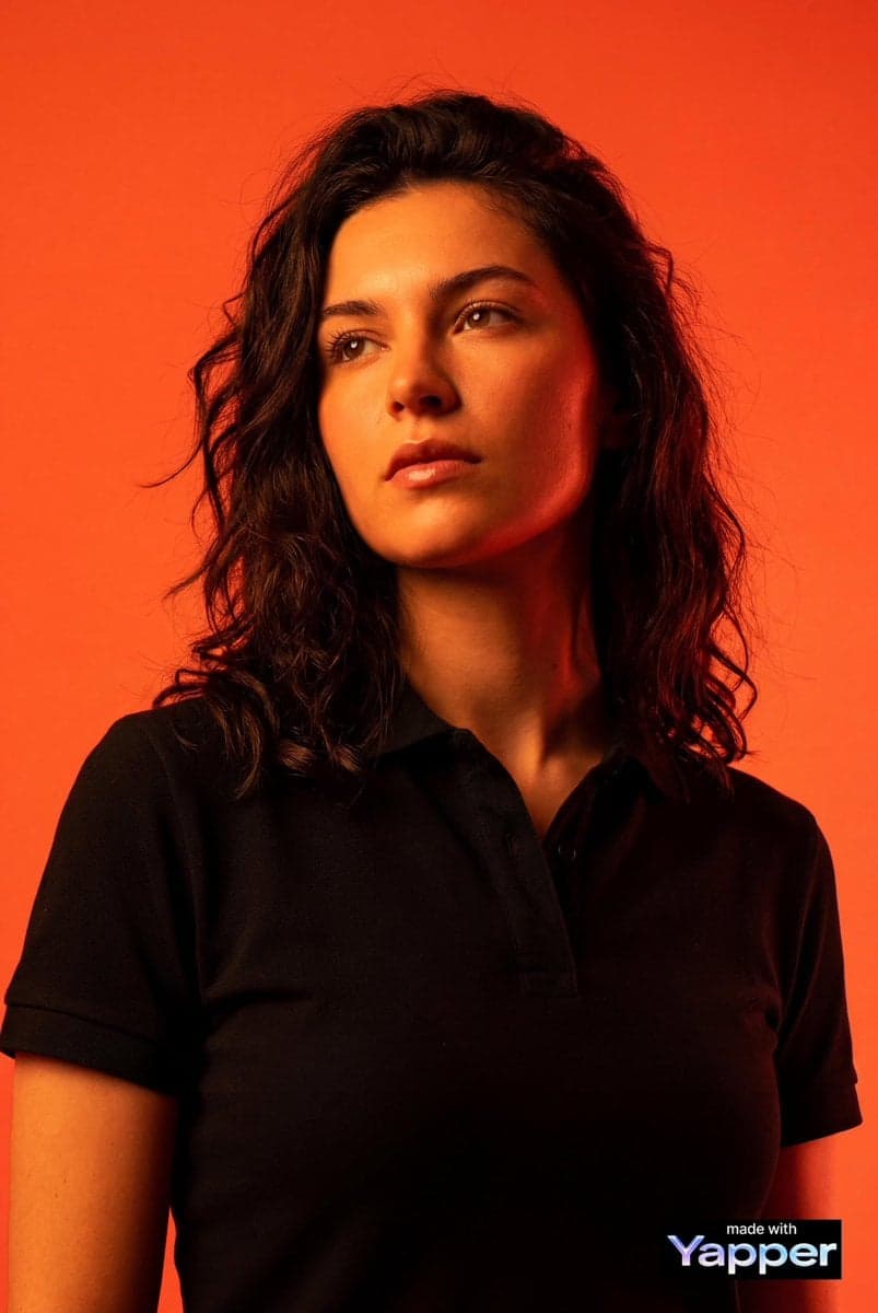 Create a high-impact editorial studio portrait using the per